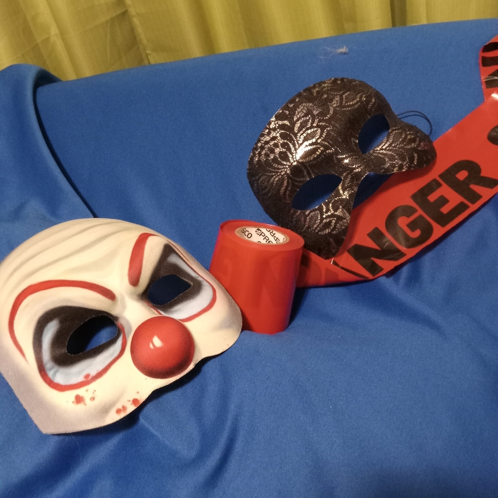 Two Halloween mask in good condition and danger and skull bones tape.